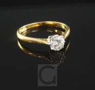 An 18ct gold and platinum solitaire diamond ring, the stone weighing approximately 0.60cts, size O.