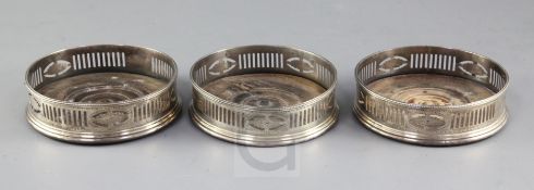 A set of three George III pierced and bright cut silver bottle coasters, maker probably Robert