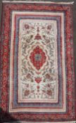 A Persian Tabriz style rug, with central medallion in a field of scrolling foliage, on a blue and