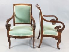A pair of French Empire style mahogany armchairs, stamped Bouchard, with scroll arms, on sabre legs,