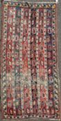 A Kazak multi coloured runner, c.1900, with field of horizontal panels with stylised botehs and