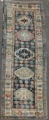 A Shirvan blue ground runner, c.1880, with five central octagons and geometric border, 10ft 4in by