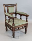 Bruce Talbot. A Victorian aesthetic movement oak armchair, with spindle turned and fluted frame,