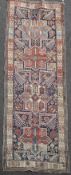 An Akstafa blue ground rug, c.1860, with field of geometric motifs, animals and flower heads, 9ft