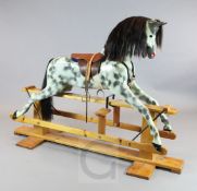 A dapple grey painted rocking horse, by Haddon Rockers, on pine trestle, H.4ft 2in. L.5ft 10in.