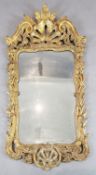 A George II carved giltwood wall mirror, with pierced scallop and scroll crest and serpentine