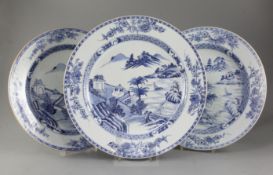 A set of three Chinese export blue and white dishes, Qianlong period, comprising a pair and a larger