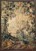 An 18th century Flemish verdure tapestry, woven with a pheasant standing before a grotto and