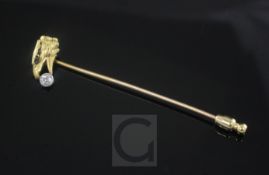 An early 20th century French 18ct gold and solitaire diamond set tie pin, modelled as an eagle's