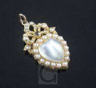 An Edwardian gold, heart shaped moonstone and split pearl set pendant, with ribbon bow motif and