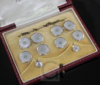 An early 20th century 9ct white gold, mother of pearl and diamond set eight piece dress stud set, in
