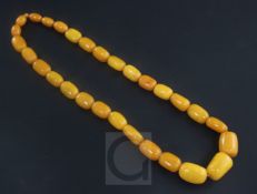 A single strand graduated oval amber bead necklace, with some similar loose beads, gross 91 grams,