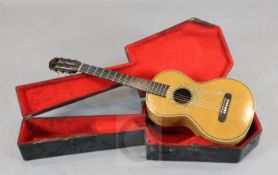 A Mirecourt Guitar circa 1880, bearing label Brugere a Mirecourt. Length of back 44.5cms, the