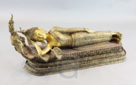 A large Thai gilt and polychrome bronze reclining figure of Buddha, possibly Mandalay period, 19th