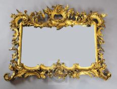 A Victorian carved giltwood overmantel, of ornate floral scroll design, W.3ft 8in. H.2ft 8in.
