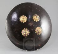 A fine Indian hide shield dhal, fitted with four gold kundun bosses set with gems, with silk knuckle