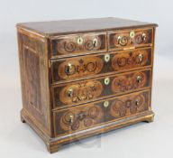 A late 17th century walnut marquetry and oyster veneered chest, decorated with foliate scrolls, on