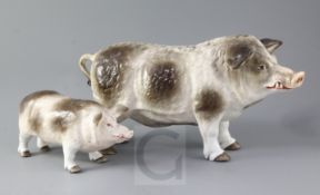 Two Continental porcelain models of standing boars, underglazed blue printed anchor mark and various