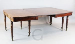 A large Regency mahogany extending dining table, with D shaped ends and three leaves, on ring turned