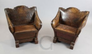 A pair of 19th century Venetian carved and painted walnut gondola chairs, with brown leather