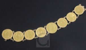 A gold mounted coin bracelet, set with eight assorted gold coins, to include six sovereigns, a 20