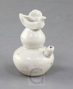 A Chinese Ding type water dropper, Song dynasty, of double gourd form surmounted by a bird finial,