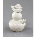 A Chinese Ding type water dropper, Song dynasty, of double gourd form surmounted by a bird finial,