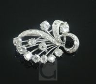 A white gold and diamond set scrolling spray brooch, 30mm.