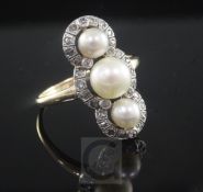 An early 20th century gold, triple cultured pearl and rose cut diamond upfinger ring, size P.