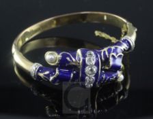 A gold, split pearl, diamond and blue enamel crossover hinged bangle, the central motif set with
