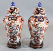 A pair of large Japanese Imari baluster vases and cover, 19th century, each painted with flowers and