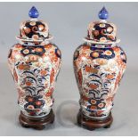 A pair of large Japanese Imari baluster vases and cover, 19th century, each painted with flowers and