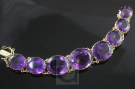 A Victorian style silver gilt and amethyst bracelet, set with eight oval facetted amethyst stones,