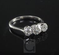 A 1930's/1940's platinum and three stone diamond ring, the three old round cut stones with an