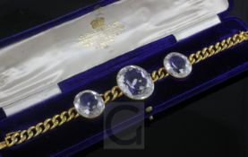 An early 20th century 15ct gold chain link bracelet set with three oval facet cut rock crystals,