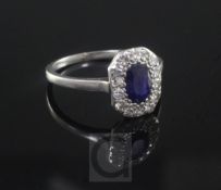 A 1920's/1930's platinum?, sapphire and diamond oval cluster ring, size M.