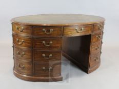 A George III mahogany oval pedestal partner's desk, with tooled green skiver, ten frieze and