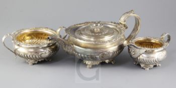A George III demi fluted silver circular three piece tea set by Joseph Angell I, with foliate