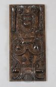 A late 16th century panel, carved with a bust of a woman, a mask and scrolls, 16 x 7.5in.