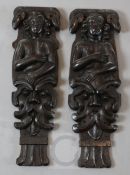 A pair of 18th century oak corbels, carved with caryatids above grotesque masks, 17in.