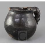A Midlands blackware lead-glazed pottery jug, 16th century, of pot-bellied form with applied rope
