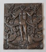A 17th century carved oak portrait of a youth flanked by griffins, 14 x 12in.