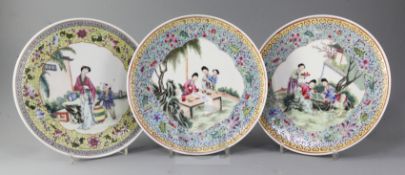 Three similar Chinese famille rose plates, mid 20th century, each painted with figures in a garden