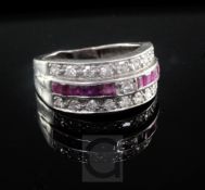 A 1940's white gold, diamond and channel set ruby triple band ring, shank a.f., size approx. K.
