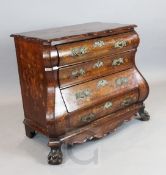 A 19th century Dutch walnut and marquetry double bombé commode, the top inlaid with flowers in a
