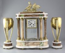 Louis Carvin. An Art Deco bronze and marble clock garniture, comprising four glass clock and pair of