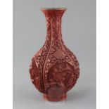 A Chinese cinnabar lacquer bottle vase, first half 20th century, carved in high relief with