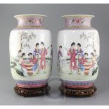 A pair of Chinese famille rose lantern shaped vases, painted with beautiful ladies amid pavilion