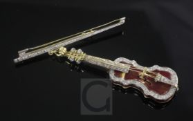 An 18ct gold, enamel and diamond set pendant modelled as a violin, suspended from a gold diamond set