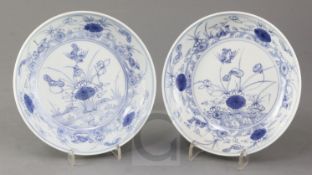 A near pair of Chinese blue and white 'mandarin duck and pond' saucer dishes, Yongzheng mark and